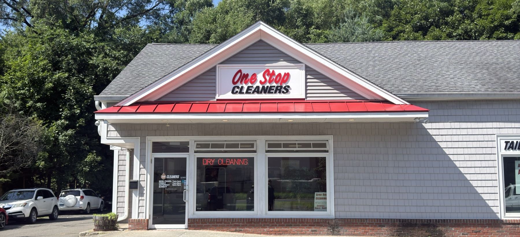 The One Stop Cleaners storefront with its red awning